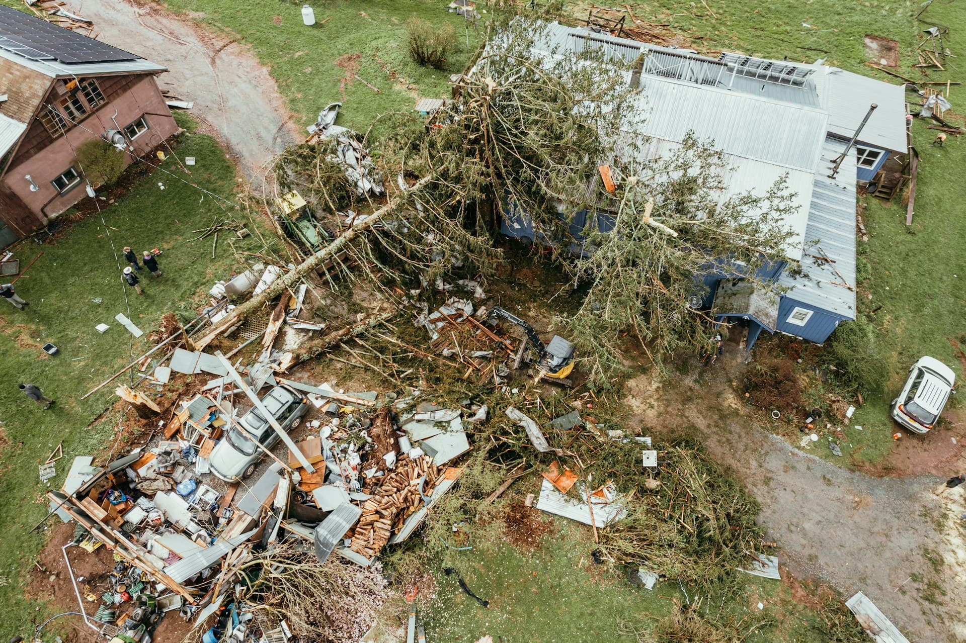 Aerial view of storm damage to a home and outbuilding after severe winds